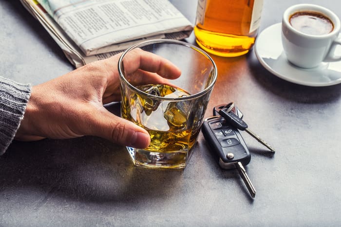 DUI Case - Glass of alcohol hand man the keys to the car