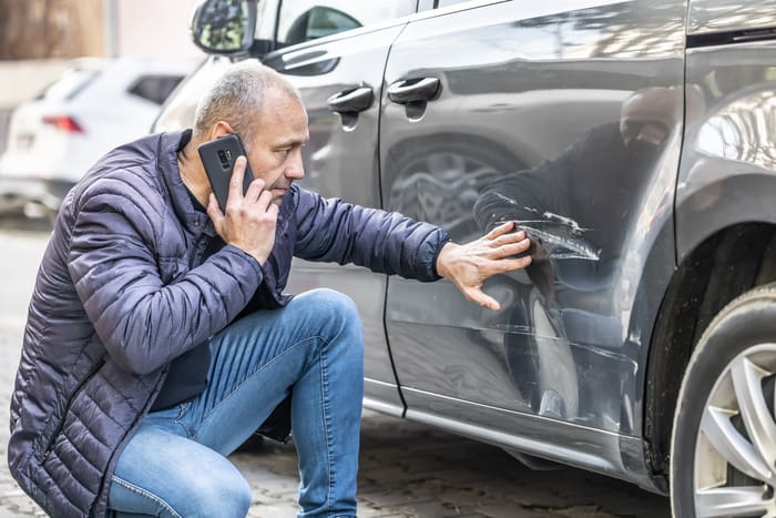 A man calls an car accident lawyer or the police after car accident