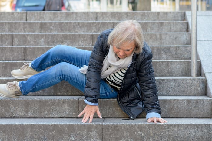senior women slip and fall down the stairs