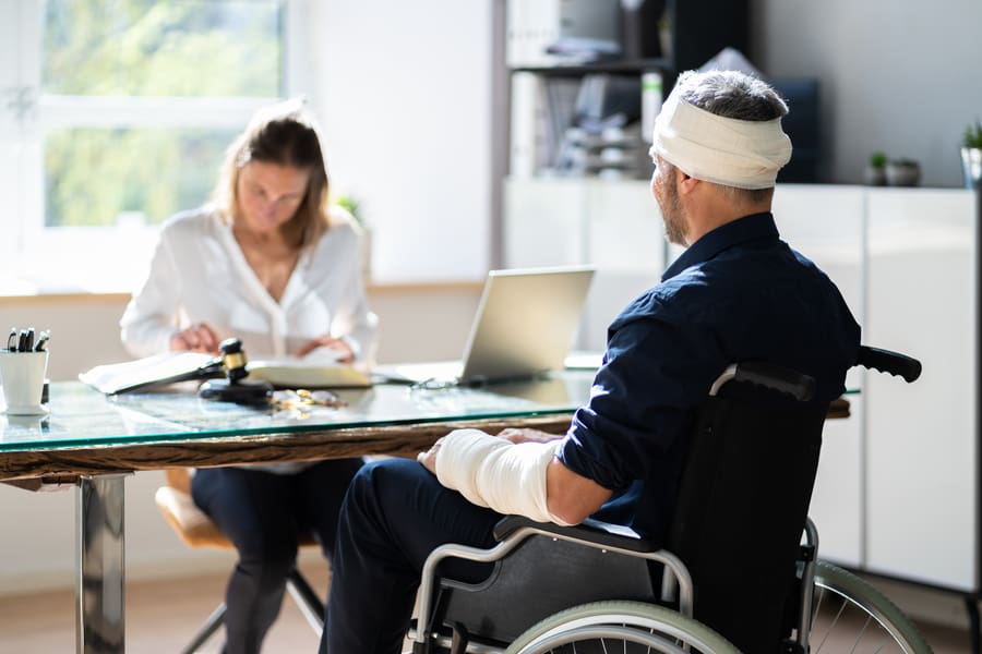 Injured man in meeting with Personal Injury Attorney
