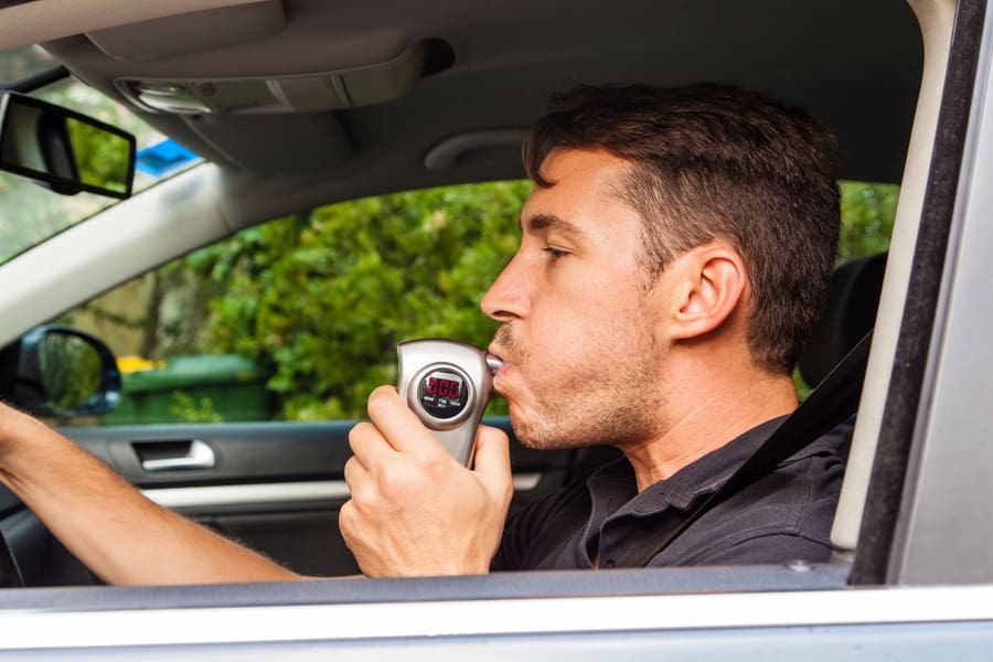 Man blowing into breathalyzer - DUI Case