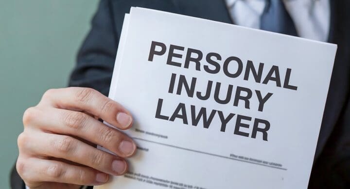 A lawyer in a suit holds a document that says personal injury lawyer in large, bold letters, offering legal representation for victims