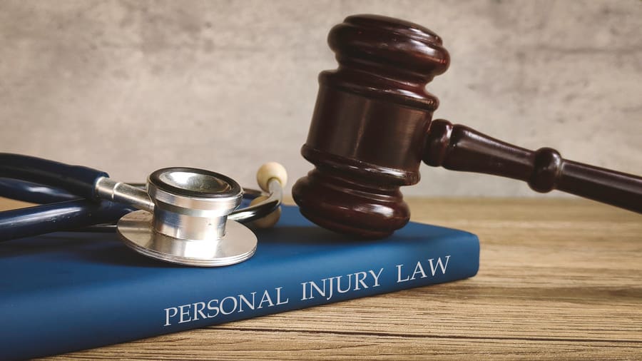 Gavel and stethoscope on a book for personal injury
