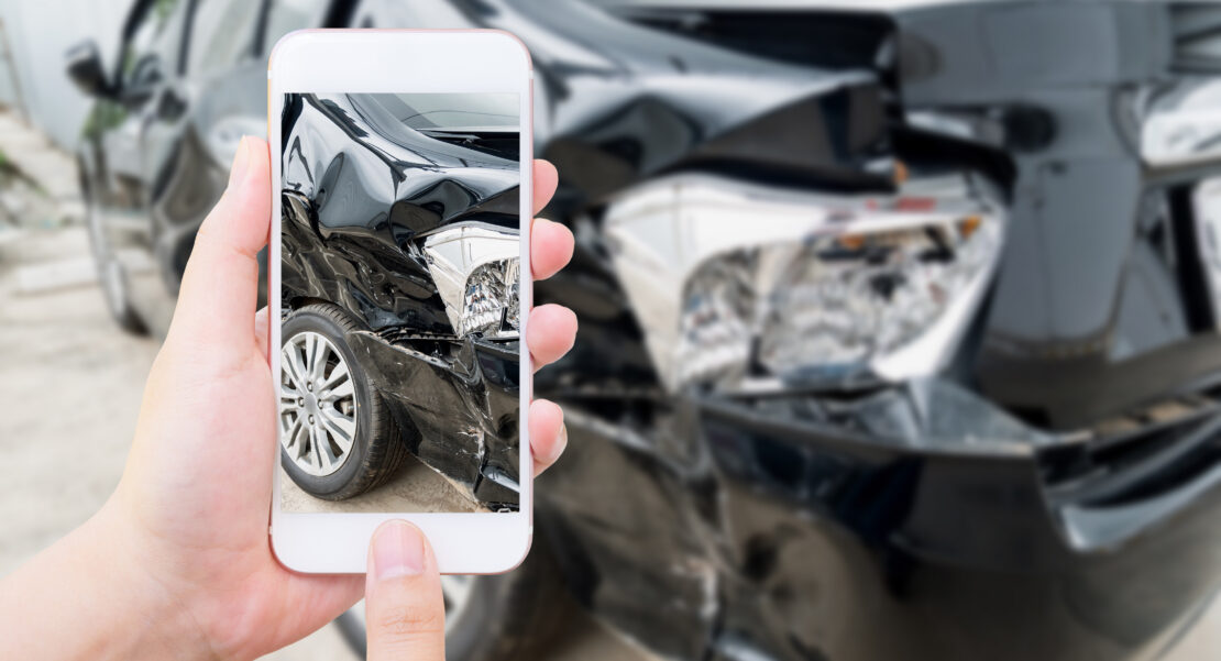 a driver collecting evidences after car crash, clicks photos with mobile phone