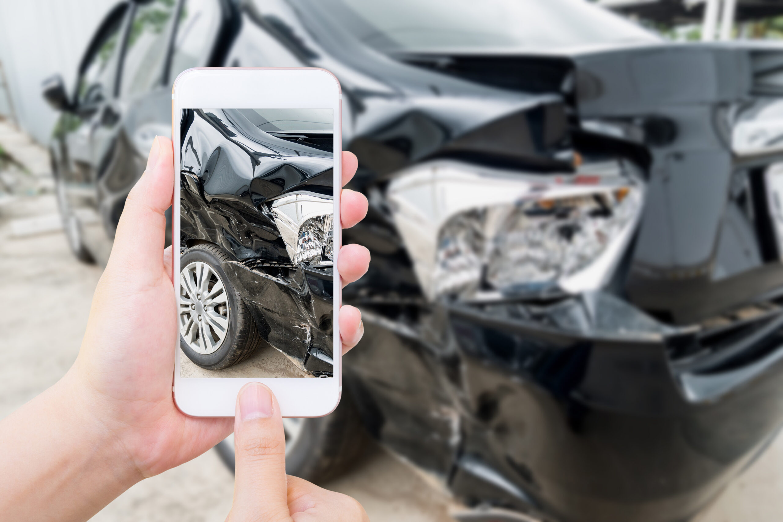 a driver collecting evidences after car crash, clicks photos with mobile phone