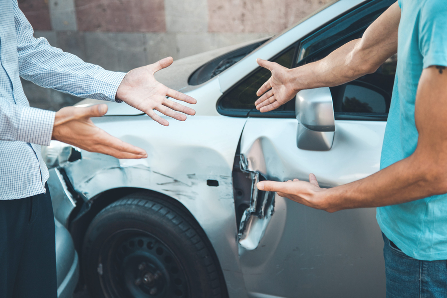 two angry man and car accident in street