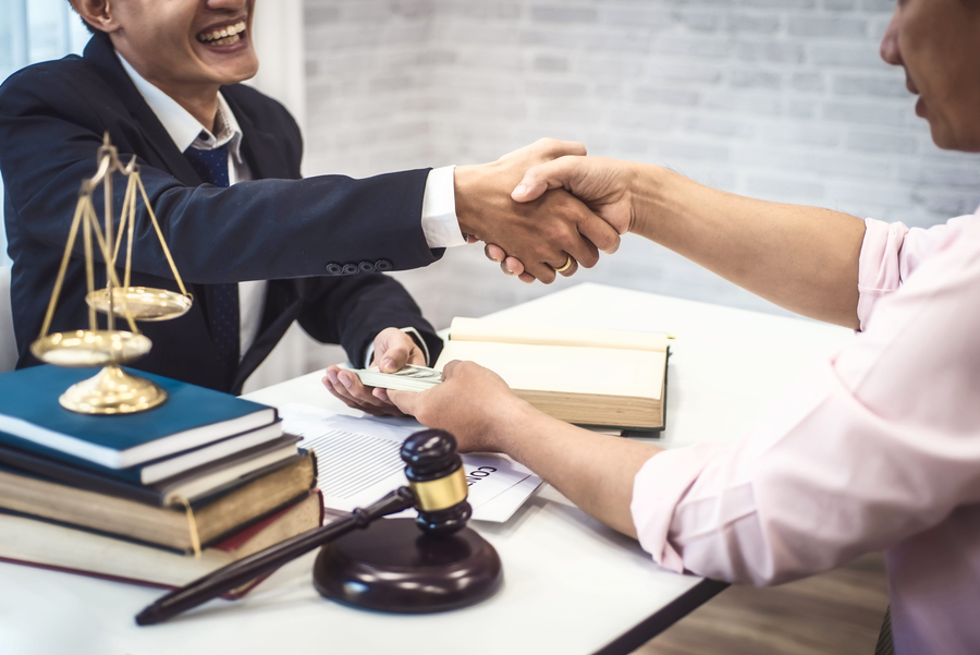 personal injury lawyer shaking hands with client