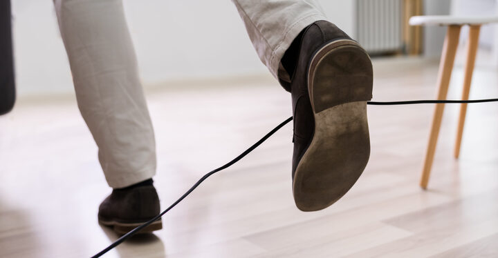 a man's feet entangled in wire and he trips to fall