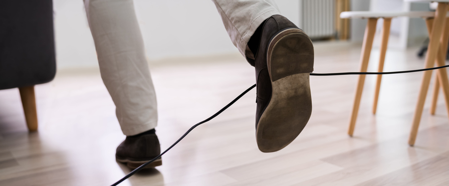 a man's feet entangled in wire and he trips to fall